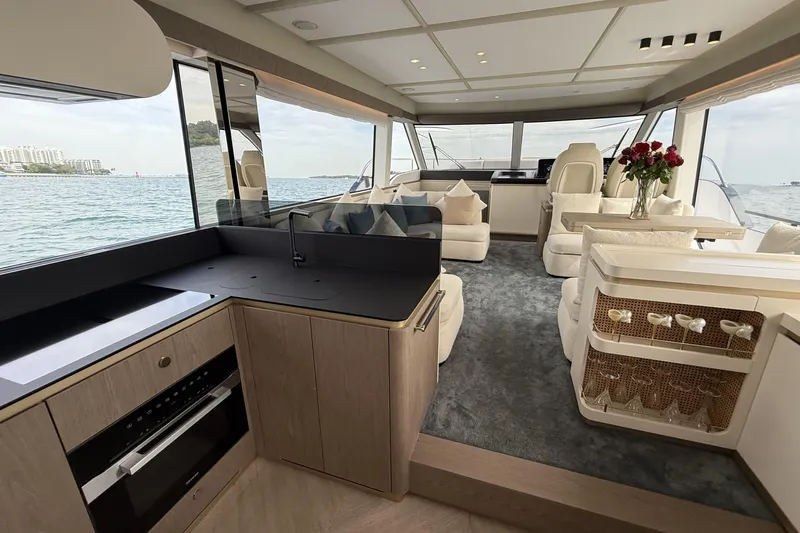  Yacht Photos Pics Luxurious interior of 2024 Azimut Magellano 60 yacht with modern kitchen and elegant seating.