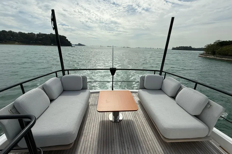  Yacht Photos Pics Luxurious 2024 Azimut Magellano 60 yacht deck with elegant seating and ocean view.