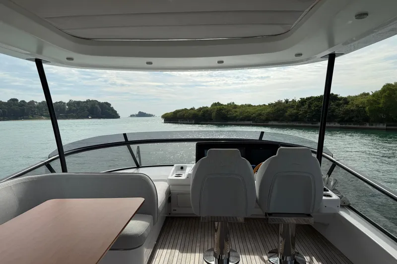  Yacht Photos Pics Interior view of 2024 Azimut Magellano 60 yacht, featuring helm and seating area.