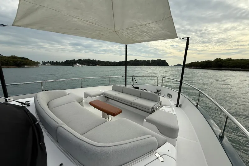  Yacht Photos Pics Luxurious 2024 Azimut Magellano 60 yacht with elegant seating and scenic water view.