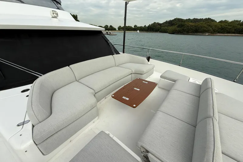  Yacht Photos Pics Luxurious seating area on 2024 Azimut Magellano 60 yacht, overlooking serene waters.