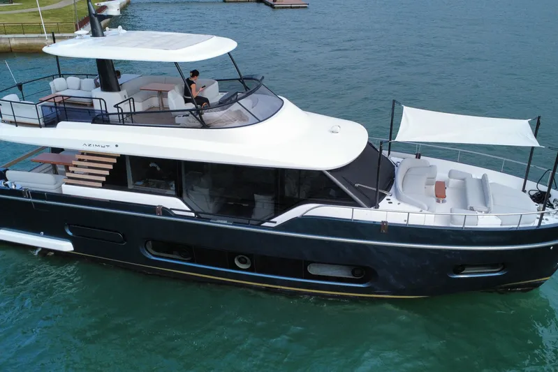  Yacht Photos Pics 2024 Azimut Magellano 60 yacht cruising on blue water, featuring elegant design and spacious decks.