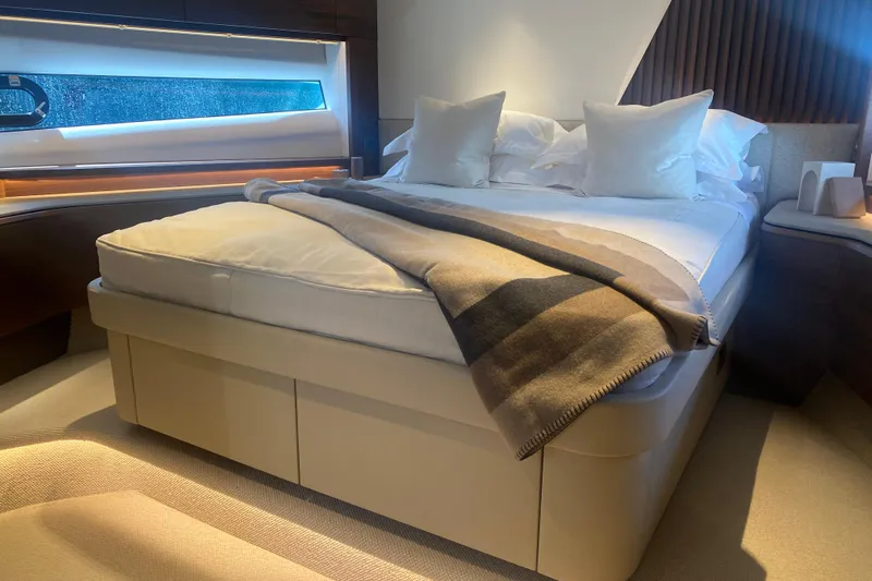  Yacht Photos Pics Luxurious bedroom interior of 2025 Princess Y72 yacht with elegant bedding and modern design.