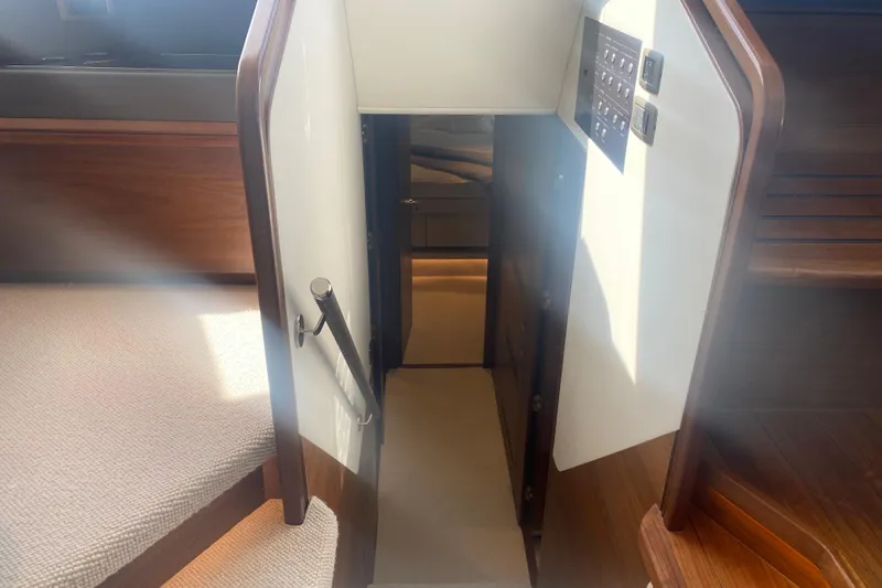  Yacht Photos Pics Stairway leading to lower deck on 2025 Princess Y72 yacht, featuring elegant wood and carpet design.