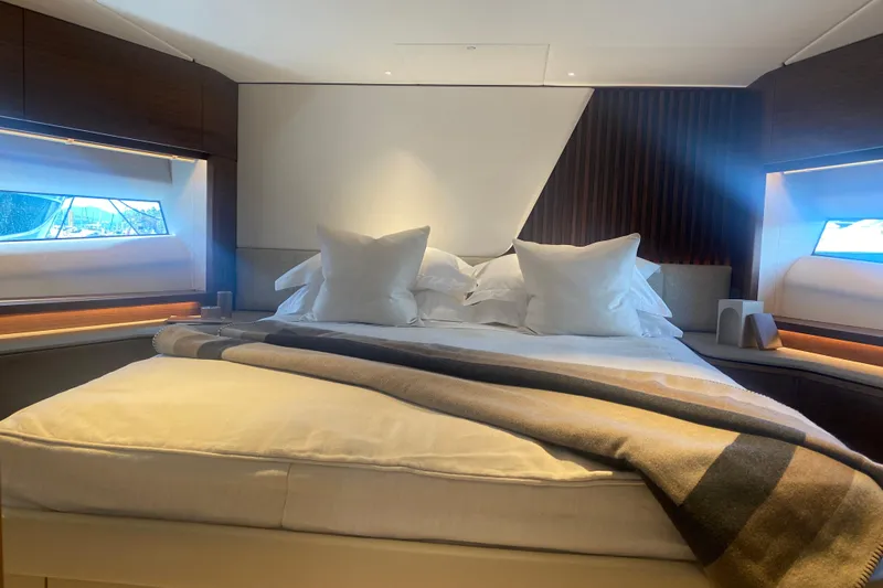  Yacht Photos Pics Luxurious bedroom interior of 2025 Princess Y72 yacht with elegant bedding and modern design.