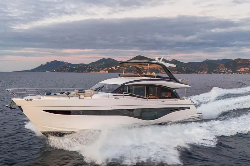  Yacht Photos Pics Luxury Princess Y72 yacht cruising on the ocean, 2025 model, with scenic coastal backdrop.