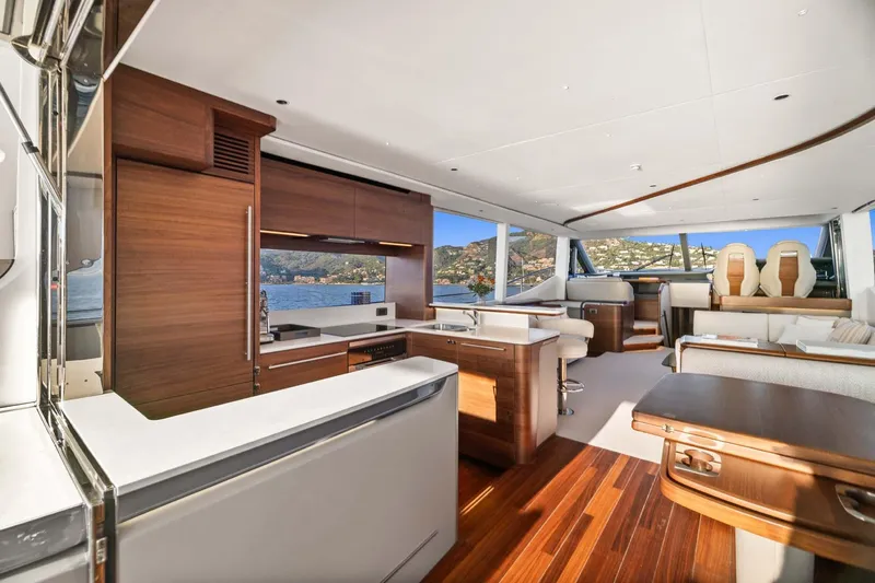  Yacht Photos Pics Luxurious interior of 2025 Princess Y72 yacht with modern kitchen and scenic ocean view.