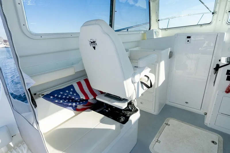  Yacht Photos Pics 2024 Steiger Craft 31 Fisherman interior with captain's chair and American flag.