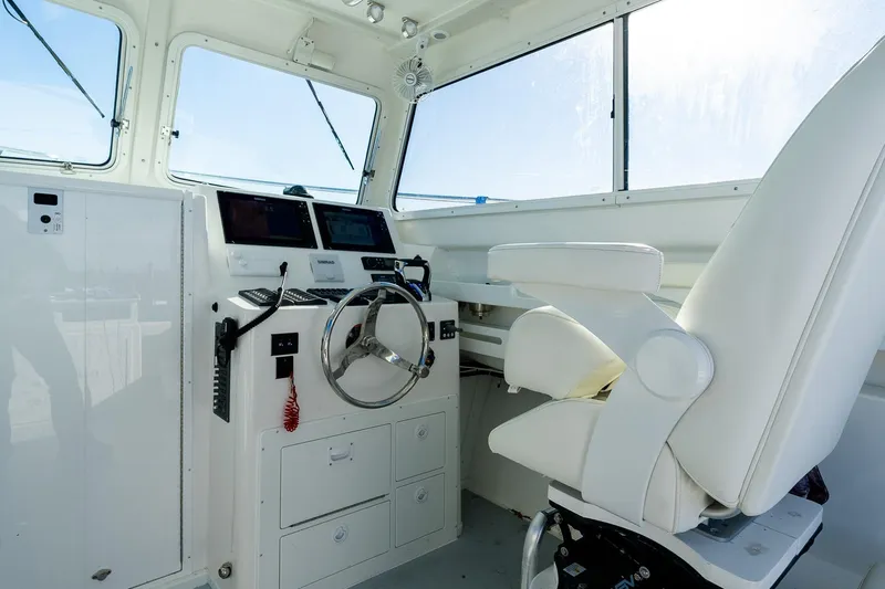  Yacht Photos Pics 2024 Steiger Craft 31 Fisherman helm with modern controls and comfortable captain's chair.