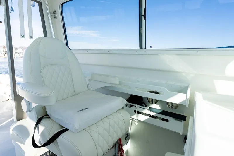  Yacht Photos Pics Luxurious interior of 2024 Steiger Craft 31 Fisherman with white seating and ocean view.