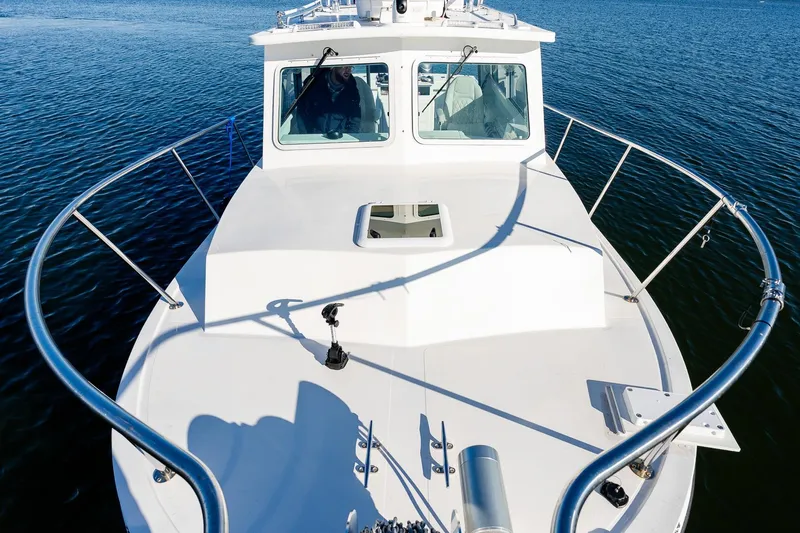  Yacht Photos Pics 2024 Steiger Craft 31 Fisherman boat on calm water, showcasing bow and cabin.