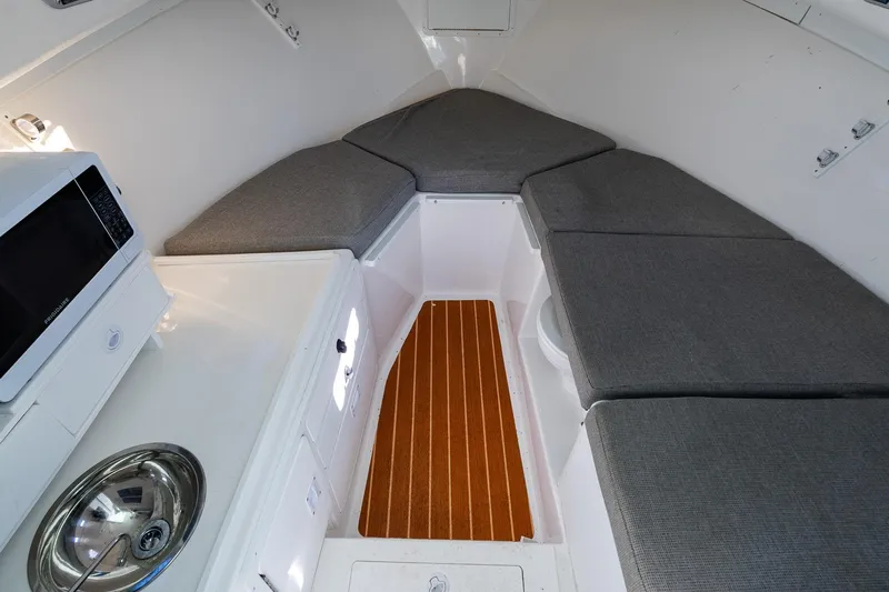  Yacht Photos Pics 2024 Steiger Craft 31 Fisherman cabin interior with seating, microwave, and sink.