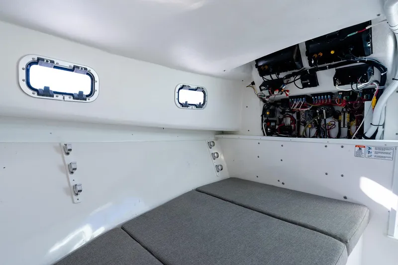  Yacht Photos Pics 2024 Steiger Craft 31 Fisherman cabin interior with wiring and cushioned seating.