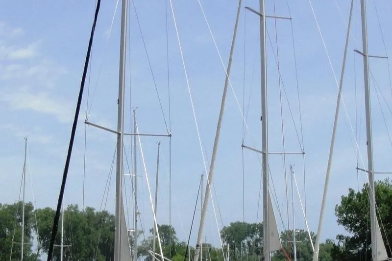  Yacht Photos Pics Masts of a 2006 Beneteau Oceanis Clipper 423 sailboat against a clear sky.
