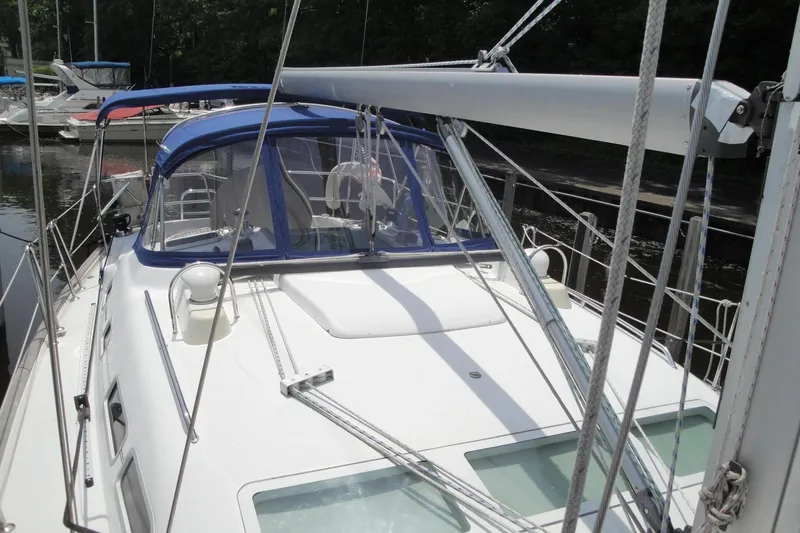  Yacht Photos Pics 2006 Beneteau Oceanis Clipper 423 sailboat docked, featuring blue canopy and sleek deck design.