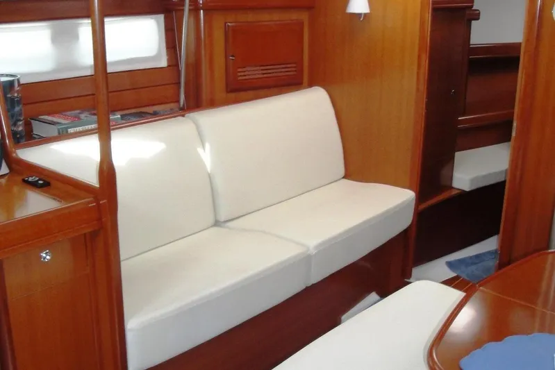  Yacht Photos Pics Interior of 2006 Beneteau Oceanis Clipper 423 with white seating and wooden finish.