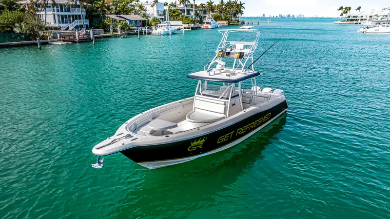  Yacht Photos Pics 2016 Stamas 390 Tarpon boat on turquoise water near coastal homes.