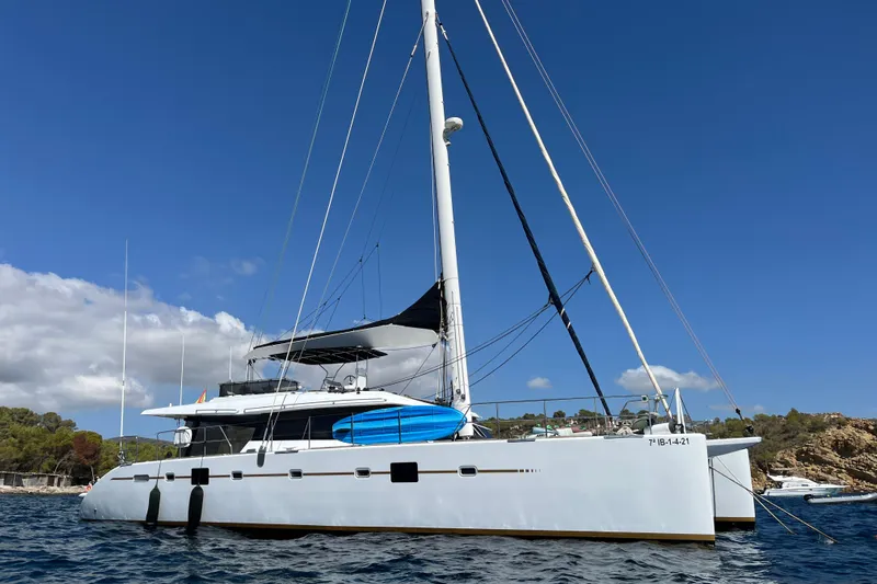 Sunreef 60 Yacht Photos Pics Sunreef 60 catamaran from 2005 anchored in scenic coastal waters.