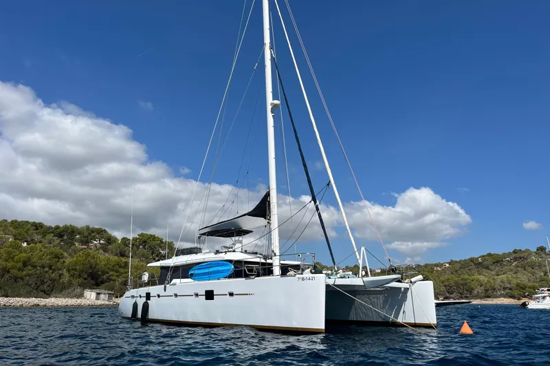 Sunreef 60 Yacht Photos Pics Luxury Sunreef 60 catamaran from 2005 anchored in scenic coastal waters.