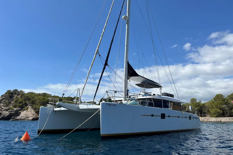 Sunreef 60 Yacht Photos Pics Luxury Sunreef 60 catamaran from 2005 anchored in scenic coastal waters.