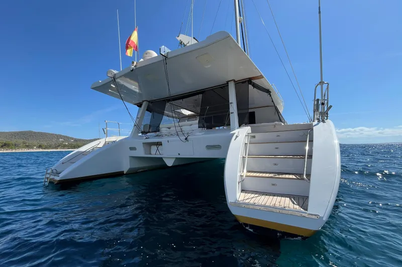 Sunreef 60 Yacht Photos Pics Luxury Sunreef 60 catamaran from 2005, anchored in clear blue waters.