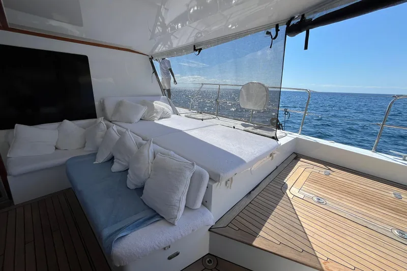 Sunreef 60 Yacht Photos Pics Luxurious Sunreef 60 yacht deck with comfortable seating, ocean view, and sunny weather.