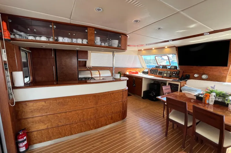 Sunreef 60 Yacht Photos Pics Luxurious interior of a 2005 Sunreef 60 yacht featuring a modern kitchen and dining area.