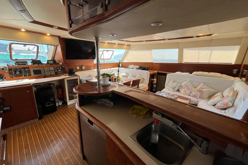 Sunreef 60 Yacht Photos Pics Luxurious interior of a 2005 Sunreef 60 yacht with modern amenities and cozy seating.