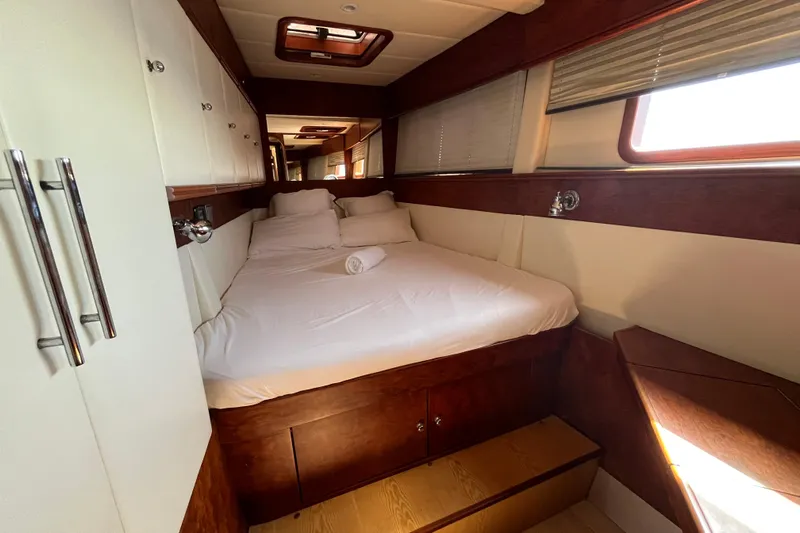 Sunreef 60 Yacht Photos Pics Luxurious cabin interior of 2005 Sunreef 60 yacht with cozy bed and wooden accents.