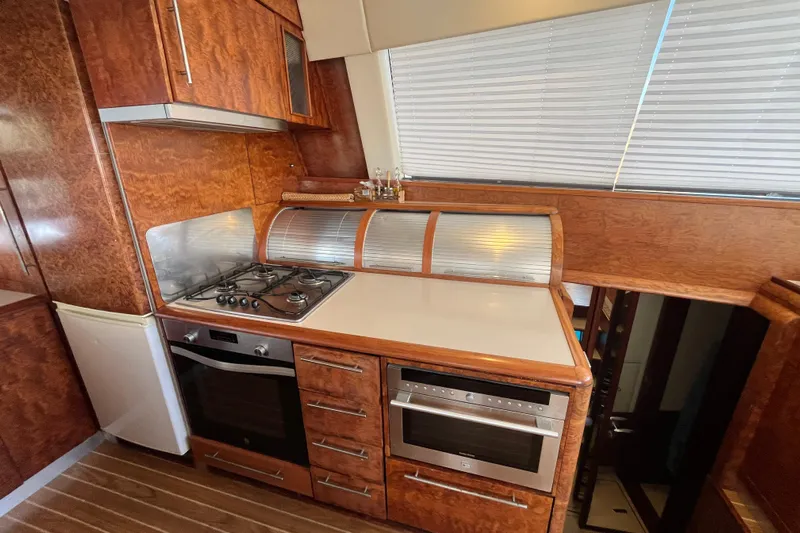 Sunreef 60 Yacht Photos Pics Luxurious wooden kitchen interior of a 2005 Sunreef 60 yacht with modern appliances.