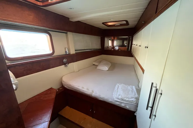 Sunreef 60 Yacht Photos Pics Luxurious cabin interior of 2005 Sunreef 60 yacht with cozy bed and wooden accents.