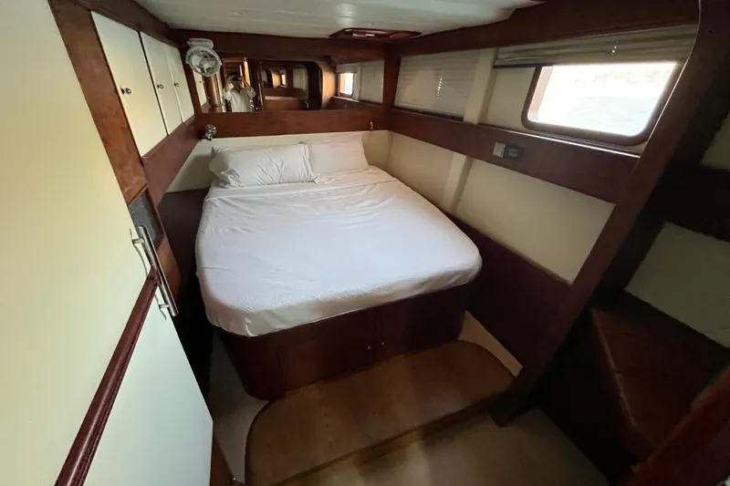 Sunreef 60 Yacht Photos Pics Luxurious cabin interior of 2005 Sunreef 60 yacht with cozy bed and wooden accents.