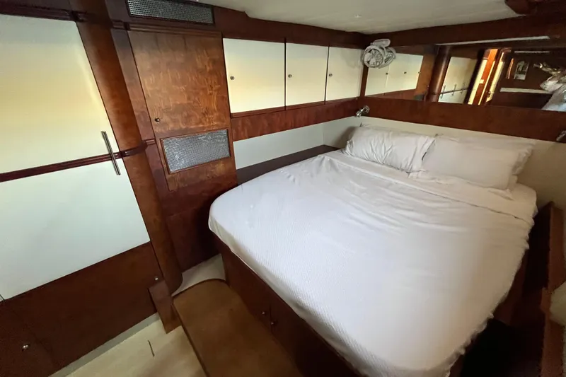 Sunreef 60 Yacht Photos Pics Luxurious cabin interior of 2005 Sunreef 60 yacht with cozy bed and wooden finishes.