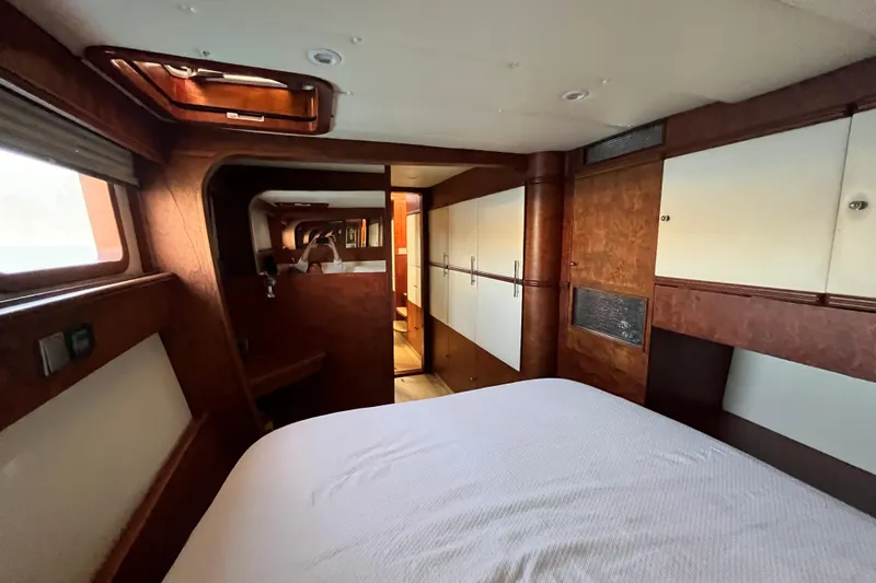 Sunreef 60 Yacht Photos Pics Luxurious interior of 2005 Sunreef 60 yacht, featuring wood paneling and cozy bedroom.