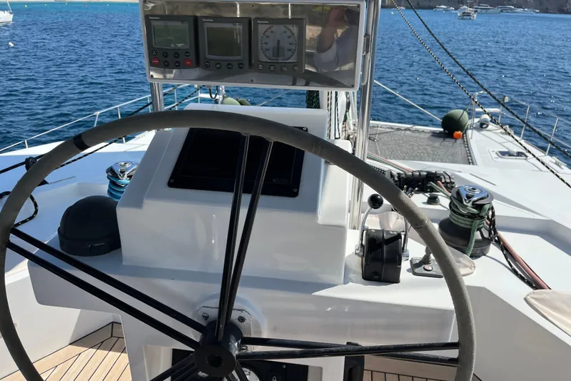 Sunreef 60 Yacht Photos Pics Steering wheel and controls of a 2005 Sunreef 60 yacht on open water.