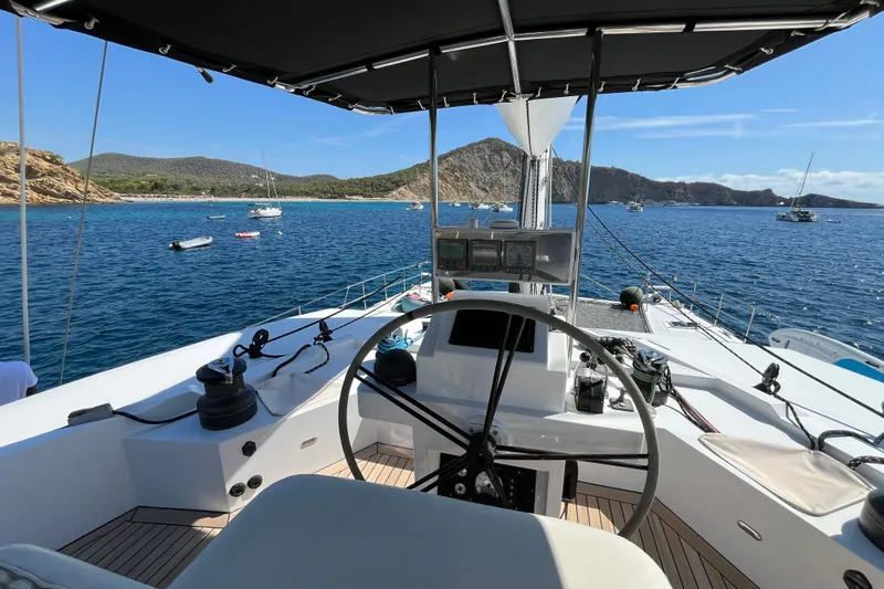 Sunreef 60 Yacht Photos Pics Helm of 2005 Sunreef 60 yacht with scenic ocean view and anchored boats.