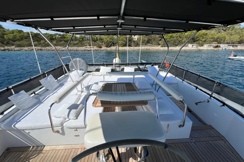 Sunreef 60 Yacht Photos Pics Luxurious Sunreef 60 yacht deck with seating, table, and scenic ocean view, 2005 model.