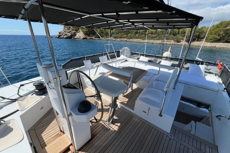 Sunreef 60 Yacht Photos Pics Luxurious 2005 Sunreef 60 yacht deck with seating, ocean view, and shaded area.