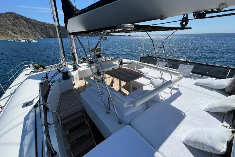 Sunreef 60 Yacht Photos Pics Luxurious Sunreef 60 yacht deck with seating, overlooking serene ocean and distant boats.