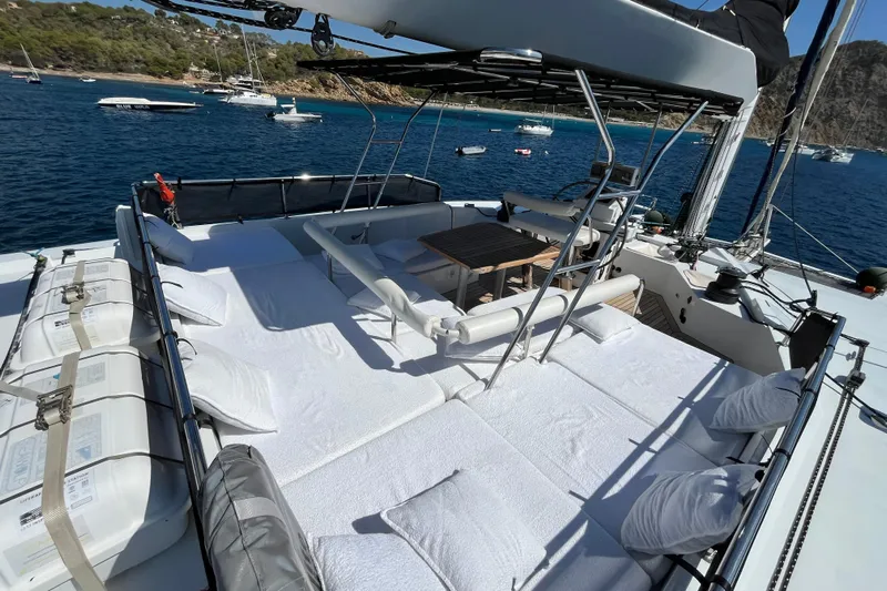 Sunreef 60 Yacht Photos Pics Luxurious Sunreef 60 yacht deck with seating, pillows, and ocean view, 2005 model.