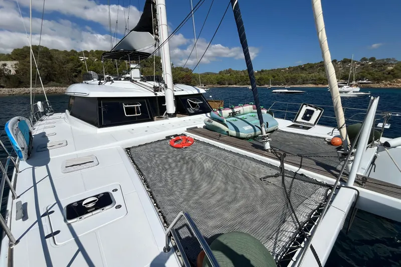 Sunreef 60 Yacht Photos Pics Sunreef 60 catamaran, 2005 model, anchored in a scenic bay with clear skies.