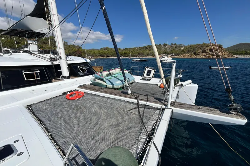 Sunreef 60 Yacht Photos Pics Sunreef 60 catamaran, 2005 model, anchored in a scenic bay with clear blue waters.