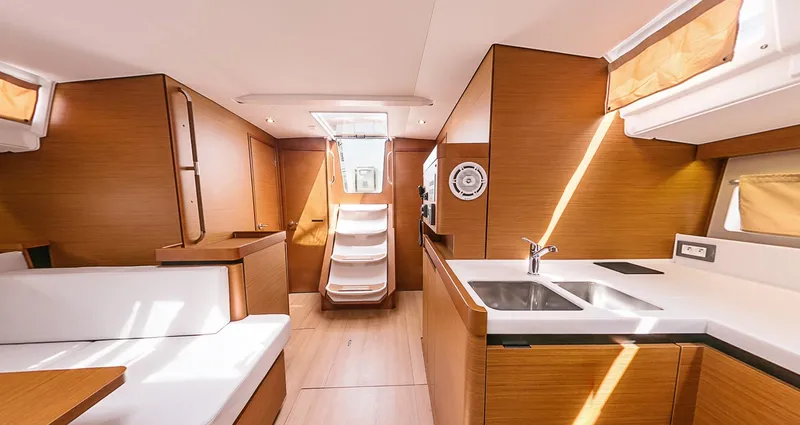 Aurora Yacht Photos Pics Interior of 2018 Jeanneau Sun Odyssey 490 yacht, featuring modern kitchen and seating area.
