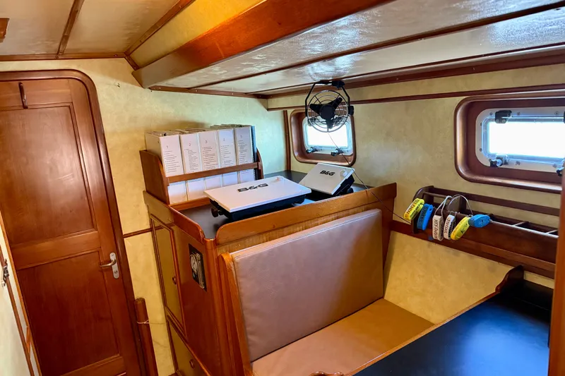 Su Ching Yacht Photos Pics Cozy interior of 1984 Tayana 55 yacht with wooden furnishings and porthole windows.