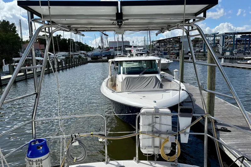 Su Ching Yacht Photos Pics Sailboat docked at marina, Tayana 55 model, 1984, with clear skies and surrounding boats.