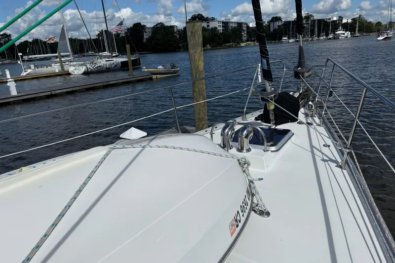 Su Ching Yacht Photos Pics 1984 Tayana 55 sailboat docked at a marina with clear skies and calm waters.