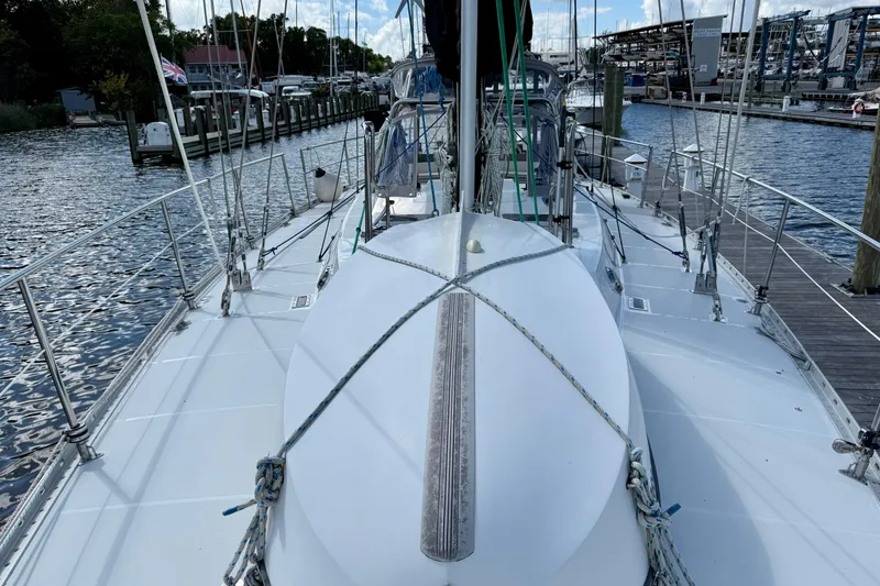 Su Ching Yacht Photos Pics 1984 Tayana 55 sailboat docked at a marina, showcasing its deck and rigging.