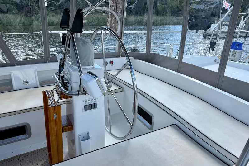 Su Ching Yacht Photos Pics Cockpit of 1984 Tayana 55 sailboat with steering wheel and seating.