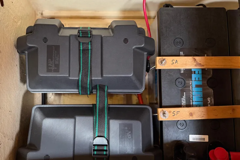 Su Ching Yacht Photos Pics Battery compartment of a 1984 Tayana 55 yacht, featuring secured battery boxes and wiring.