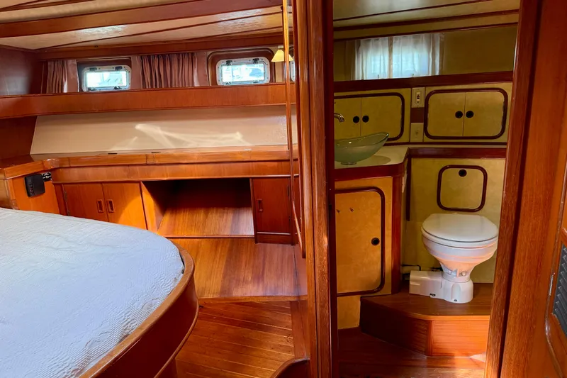 Su Ching Yacht Photos Pics Interior of 1984 Tayana 55 yacht with wooden furnishings and compact bathroom.
